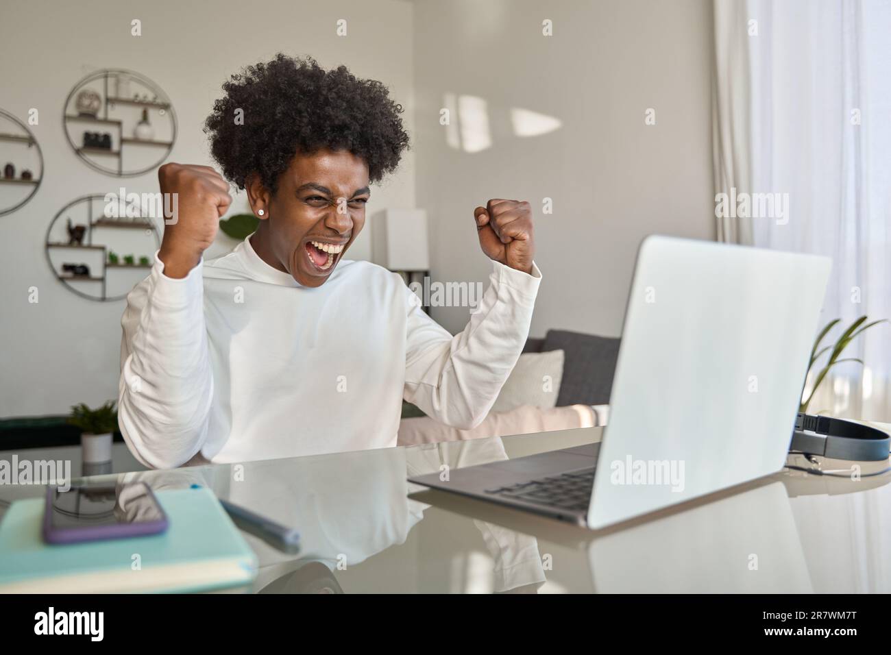 Excited African teen student winner receiving scholarship looking at ...