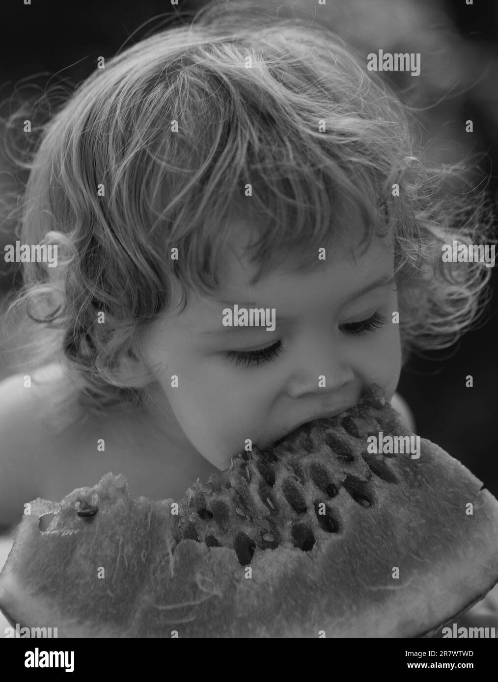 Happy child eating watermelon. Child baby eating watermelon in the