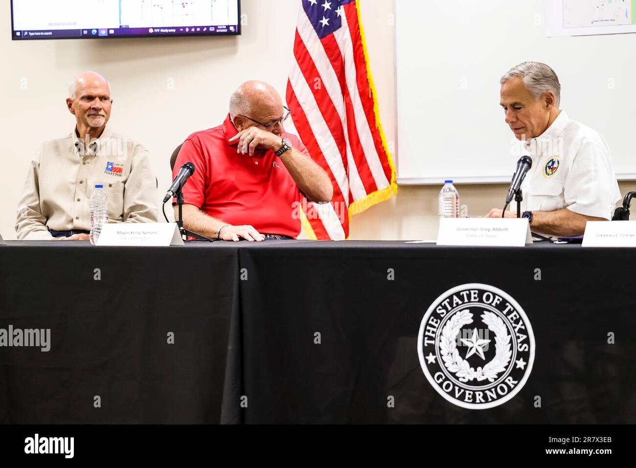 Perryton Mayor Kerry Symons, center, emotional as he and city manager David Landis, left