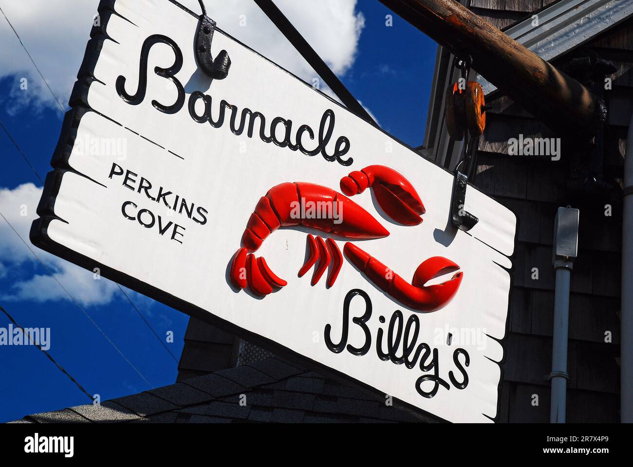 A sign advertising a café hangs over a local lobster shack in Ogunquit