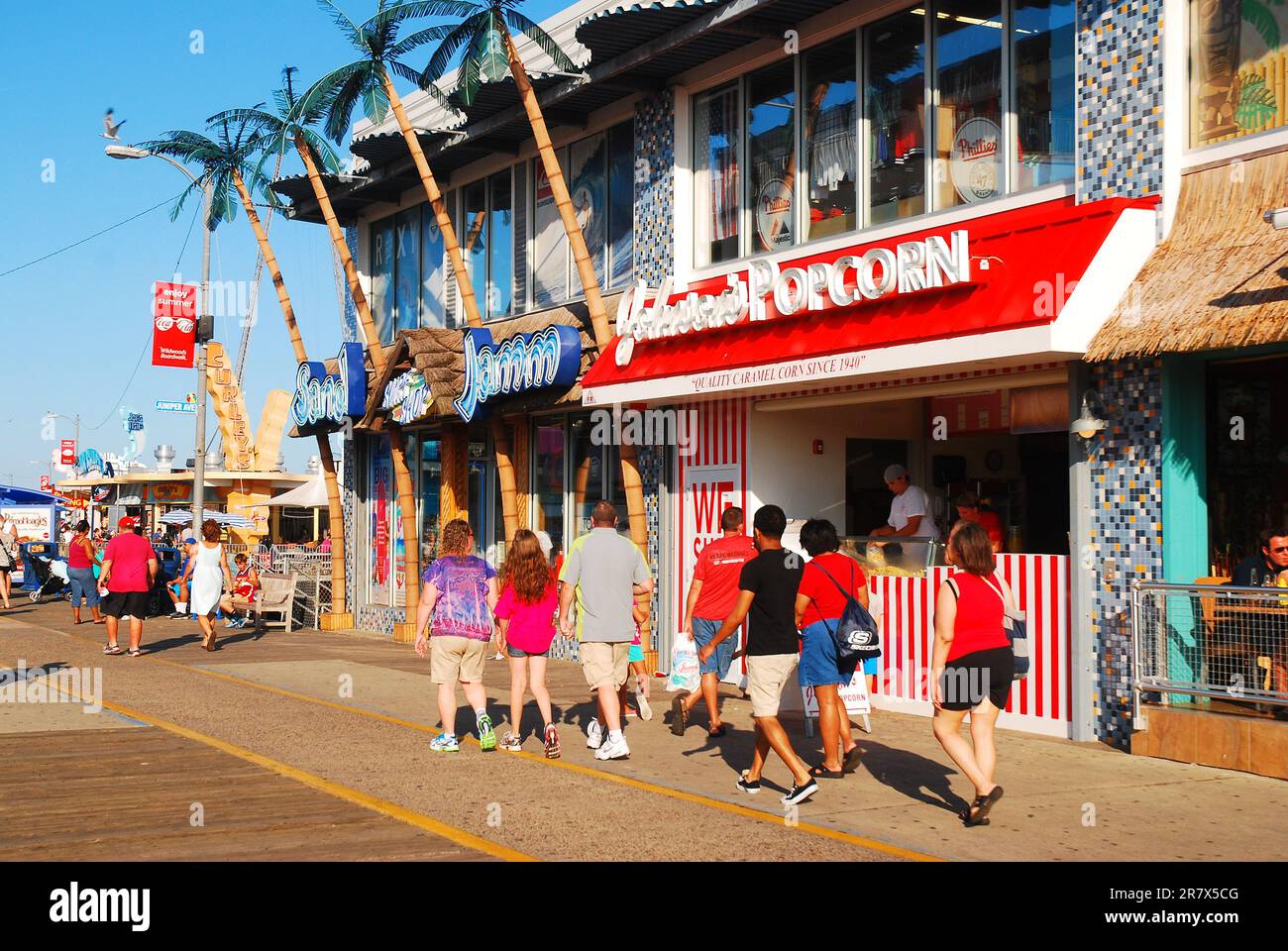 Families stroll on the Wildwood, New Jersey boardwalk on a sunny summer vacation day on the Jersey Shore Stock Photo
