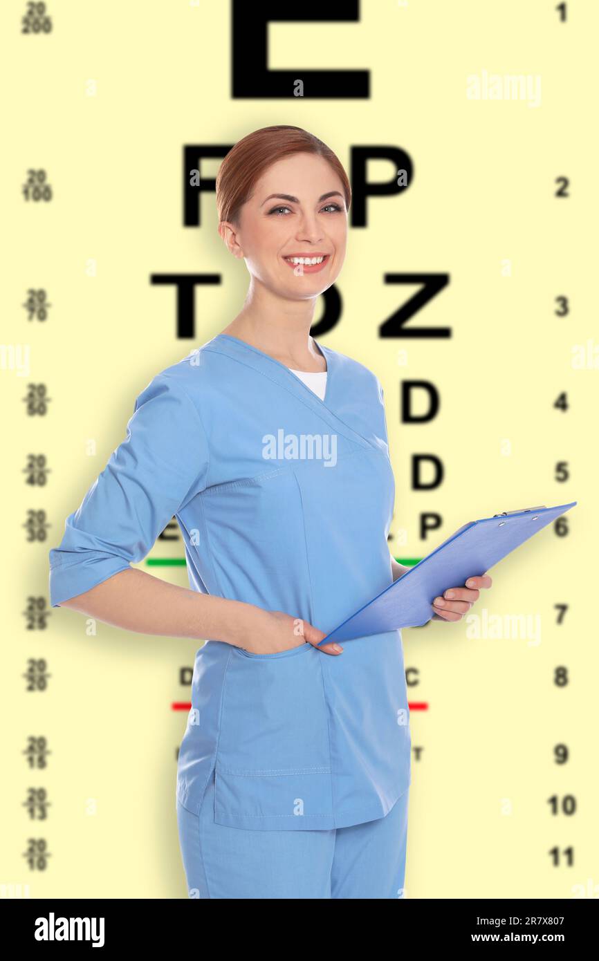 Vision test. Ophthalmologist or optometrist against pale yellow background with eye chart Stock Photo