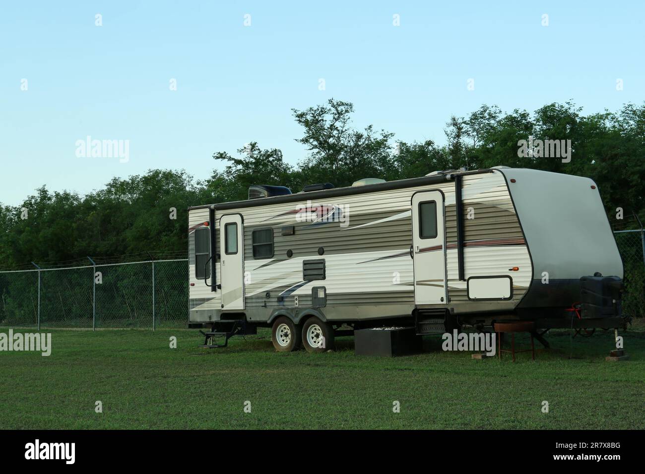 Travel trailer parked outdoors. Home on wheels Stock Photo