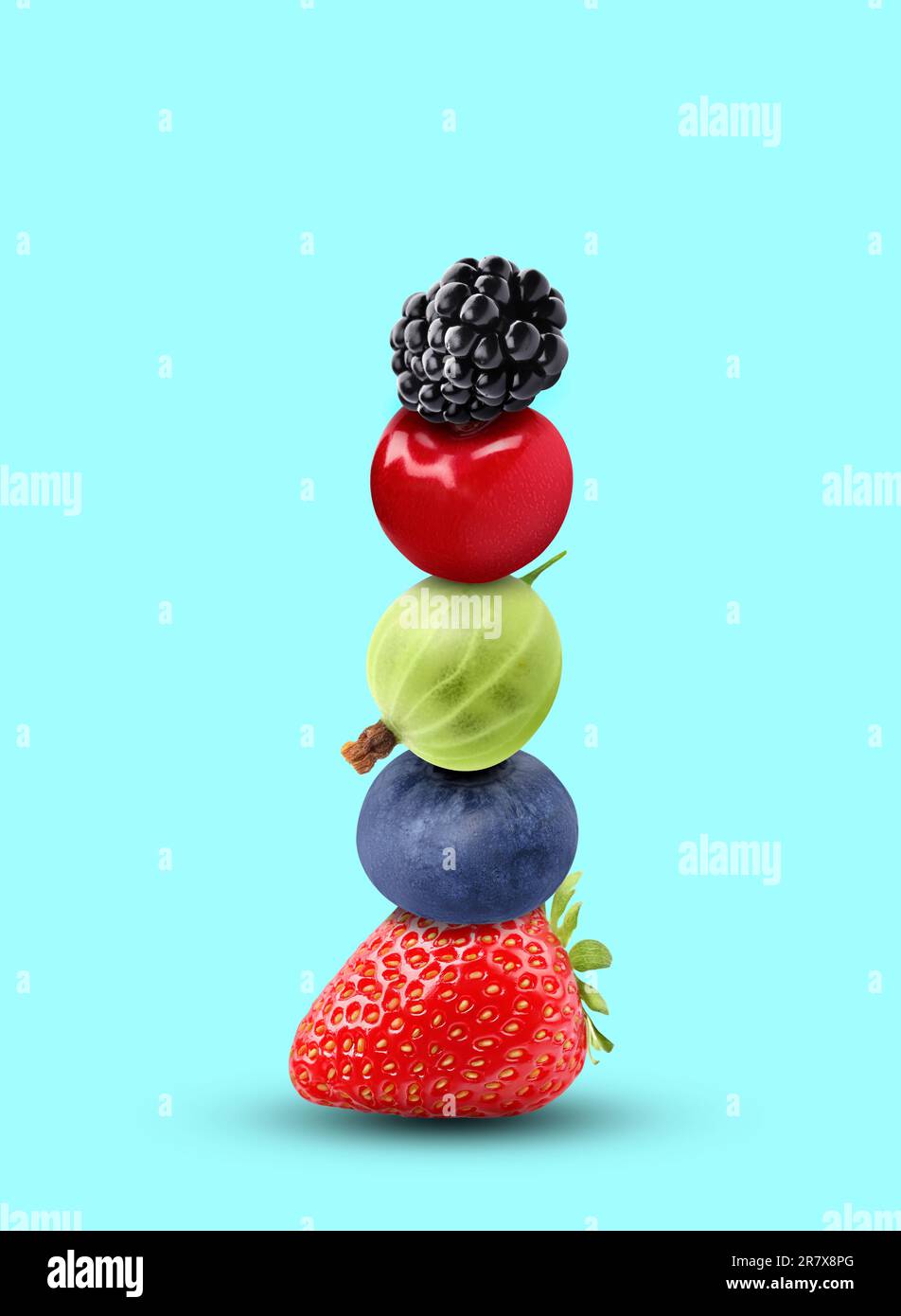 Stack of different fresh tasty berries and cherry on cyan background ...