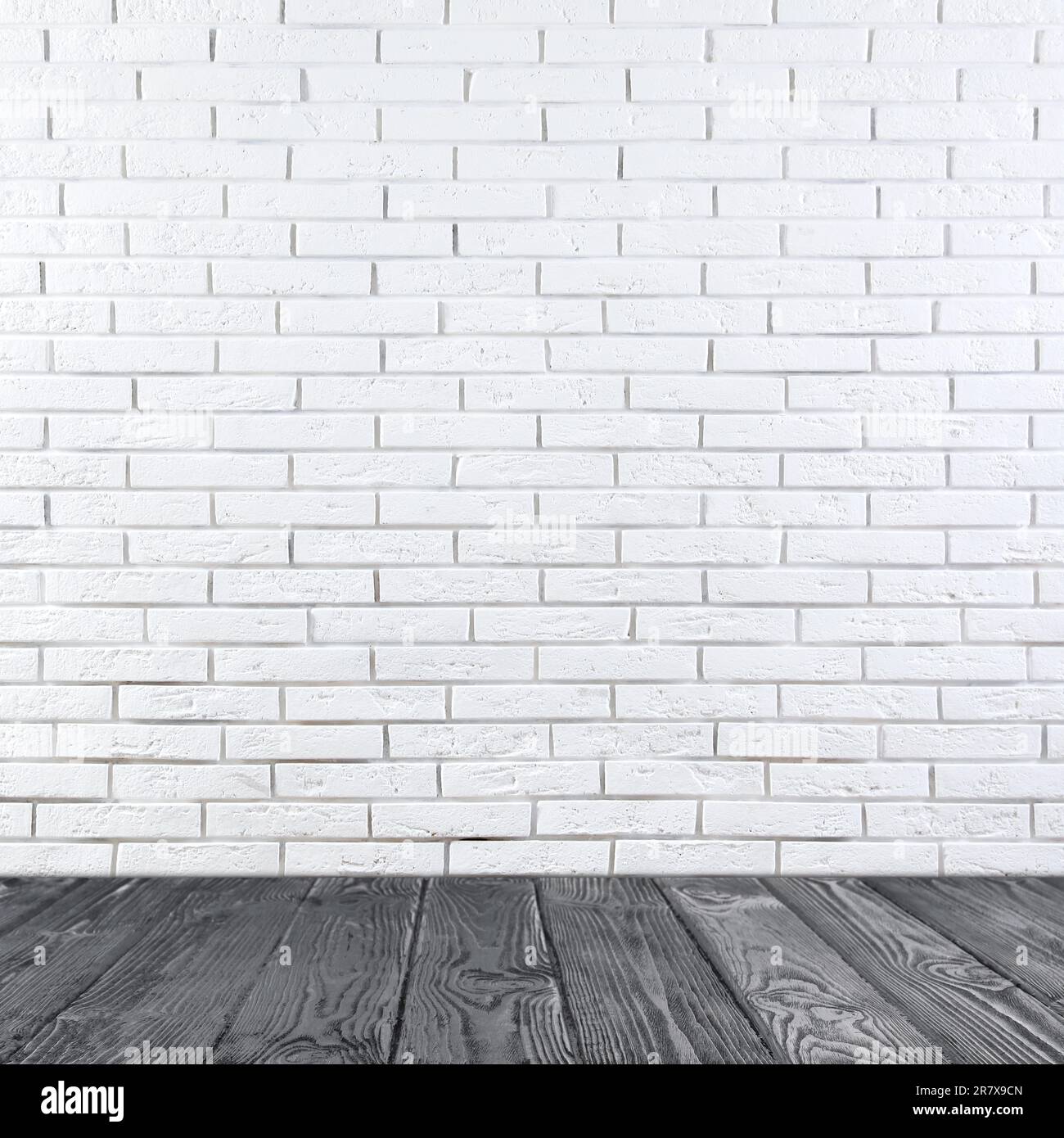Room with white brick wall and wooden floor Stock Photo - Alamy