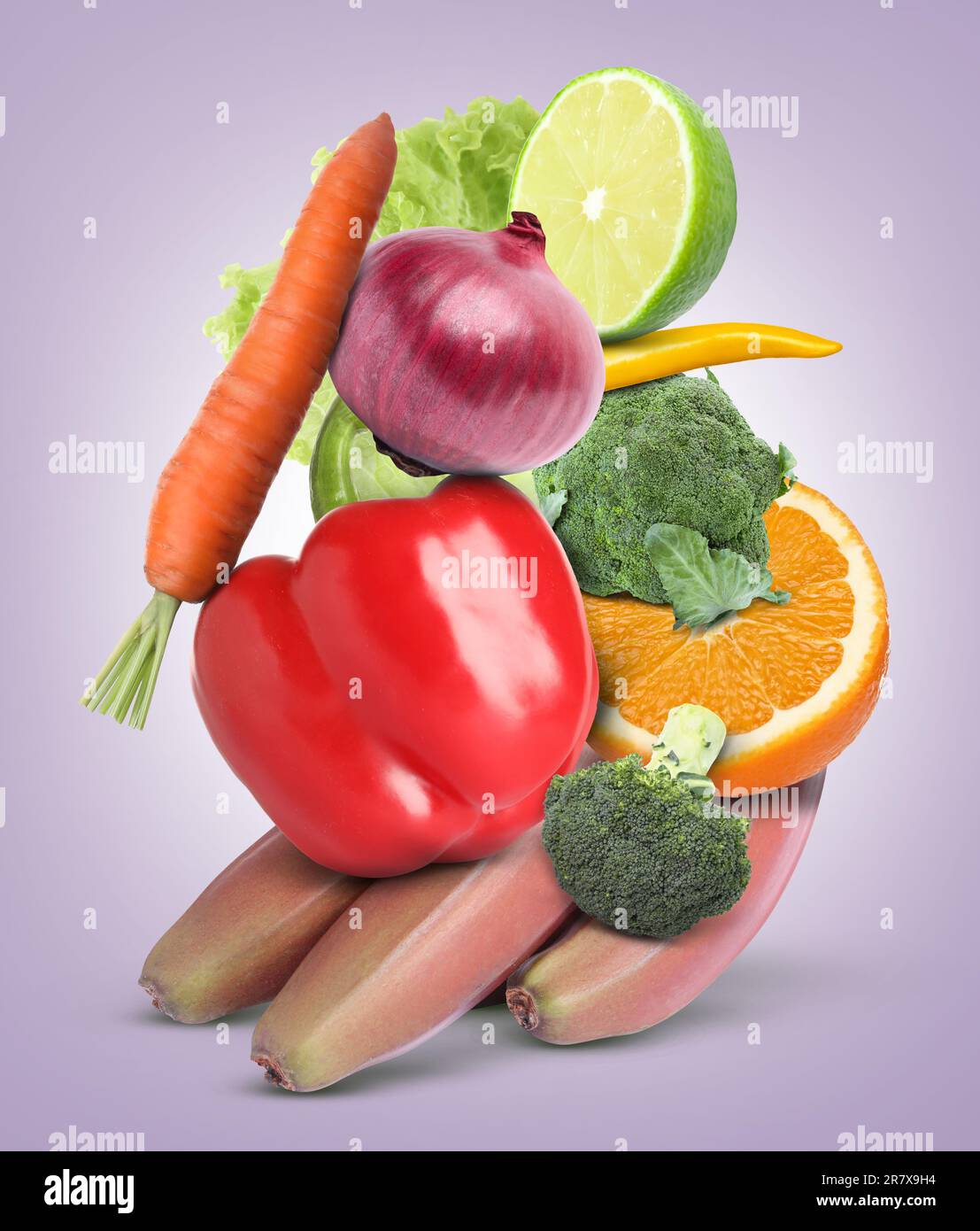 Stack of different vegetables and fruits on pale light violet background Stock Photo