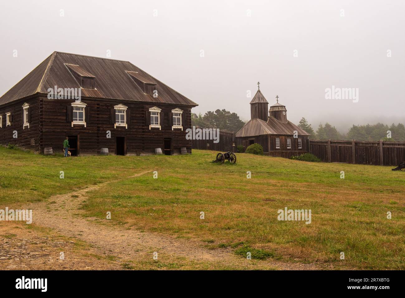 Fort Ross, 14 May 2023. Old Building and church and canon at Fort Ross state park, a Russian Fort, on a typical overcast day, California, USA Stock Photo
