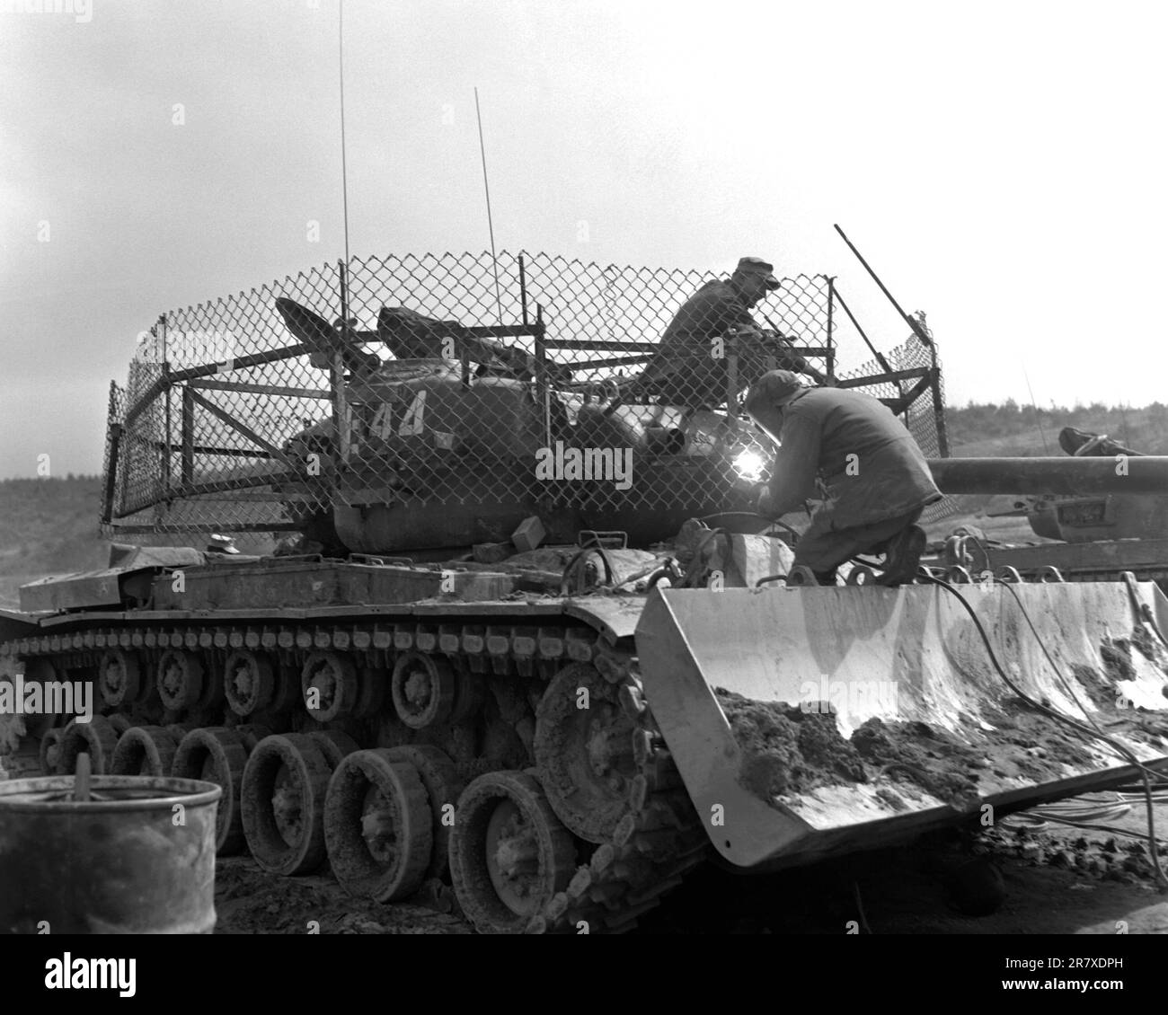 An M-46 Patton tank dozer of Dog Company, 1st Tank Battalion, with a wire fence cage around the turret, which was designed to explode 3.5 rockets the enemy is firing before they hit the tank.  The wire fence turns with the turret. Stock Photo