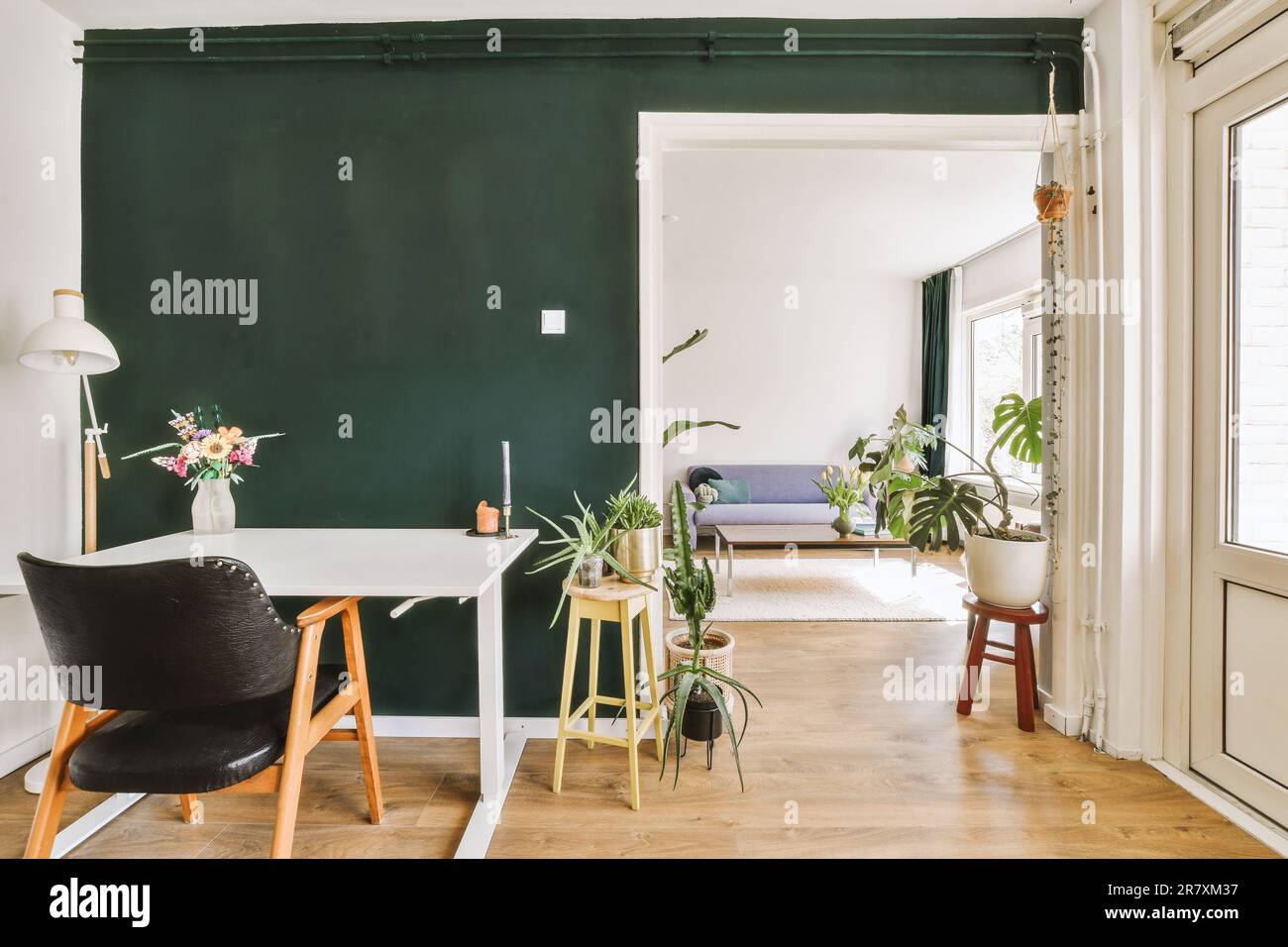 a living room with dark green walls and white trim on the walls there ...