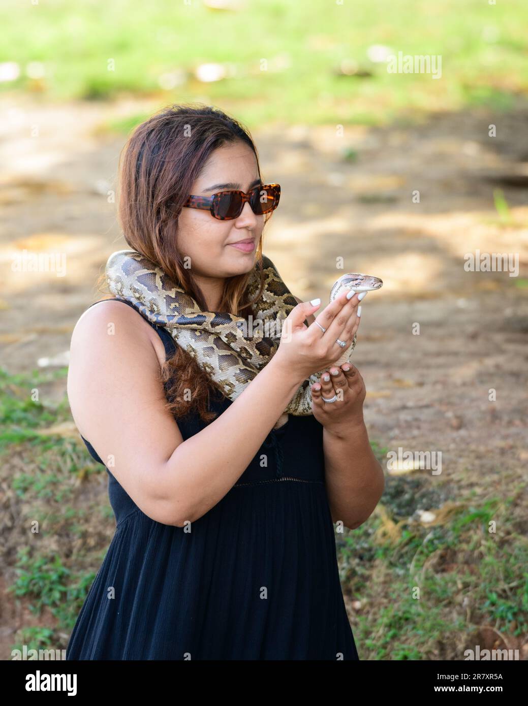 Woman with snake wrapped around her body Stock Photo - Alamy