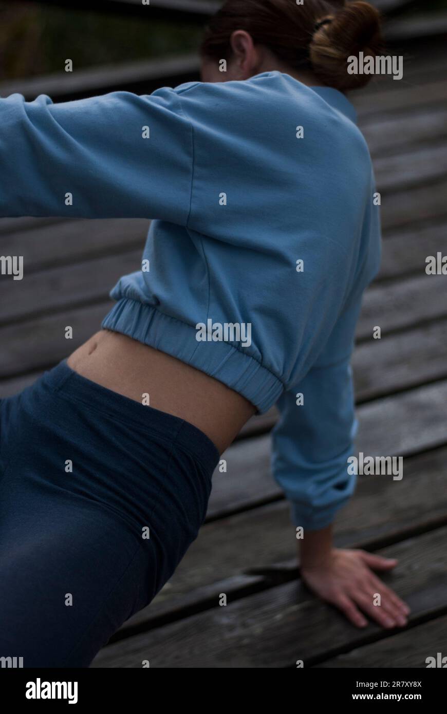 View of aestetic body of a girl in blue gym suit in the park Stock ...