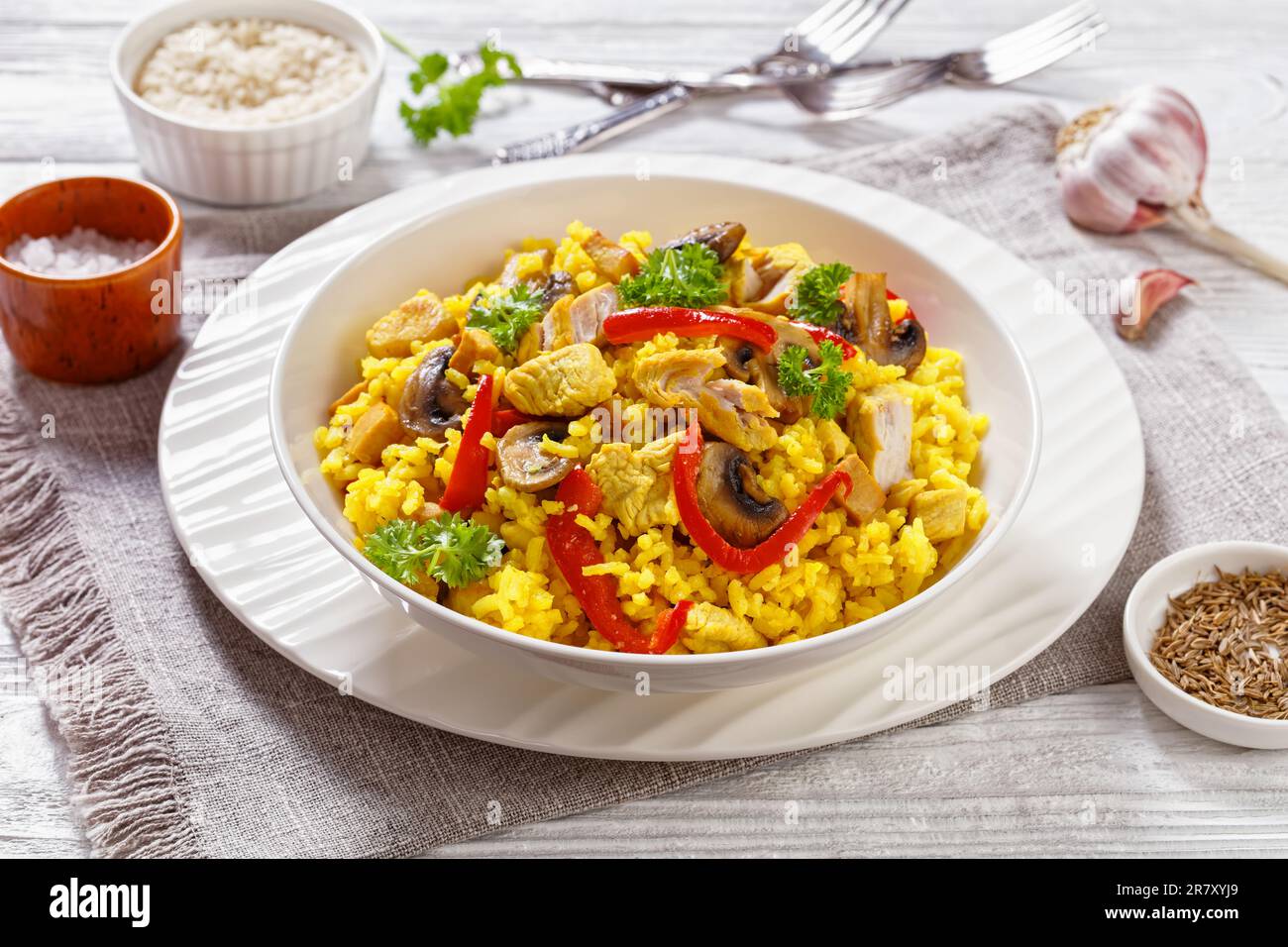 Chicken Paella of arborio rice, chicken fillet, mushrooms, julienned