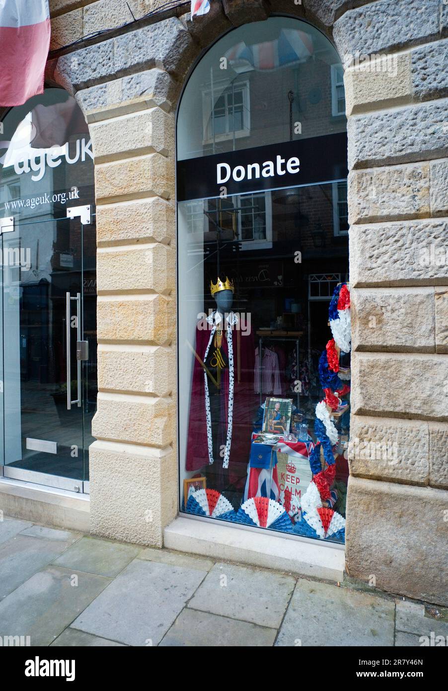 Charity shop in Stockport with a window display to celebrate the coronation of King Charles III Stock Photo