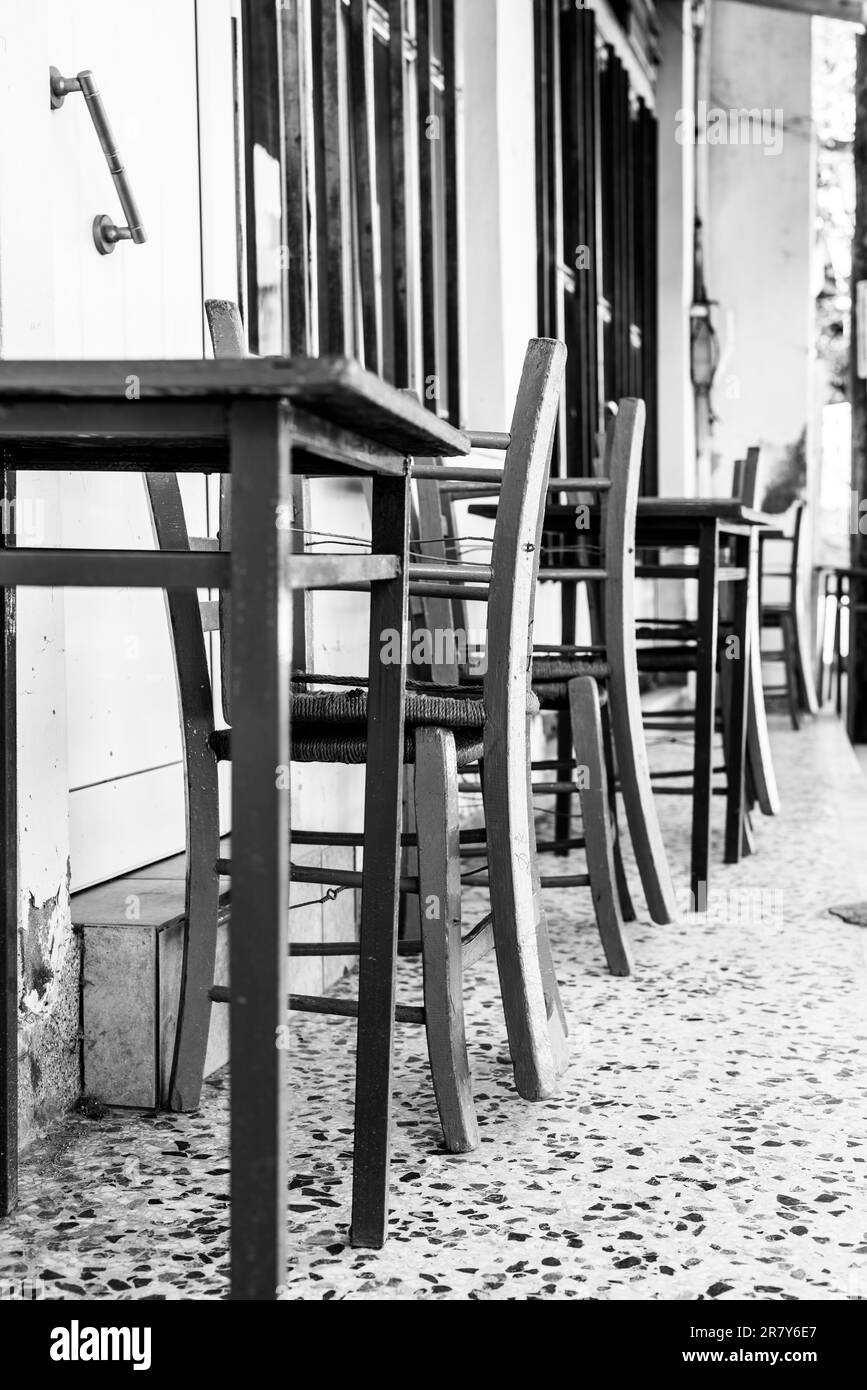 Monochrome picture with table and chairs in the village Pitsidia in the south of Crete. Pitsidia is situated in the south of the Ida mountain range Stock Photo