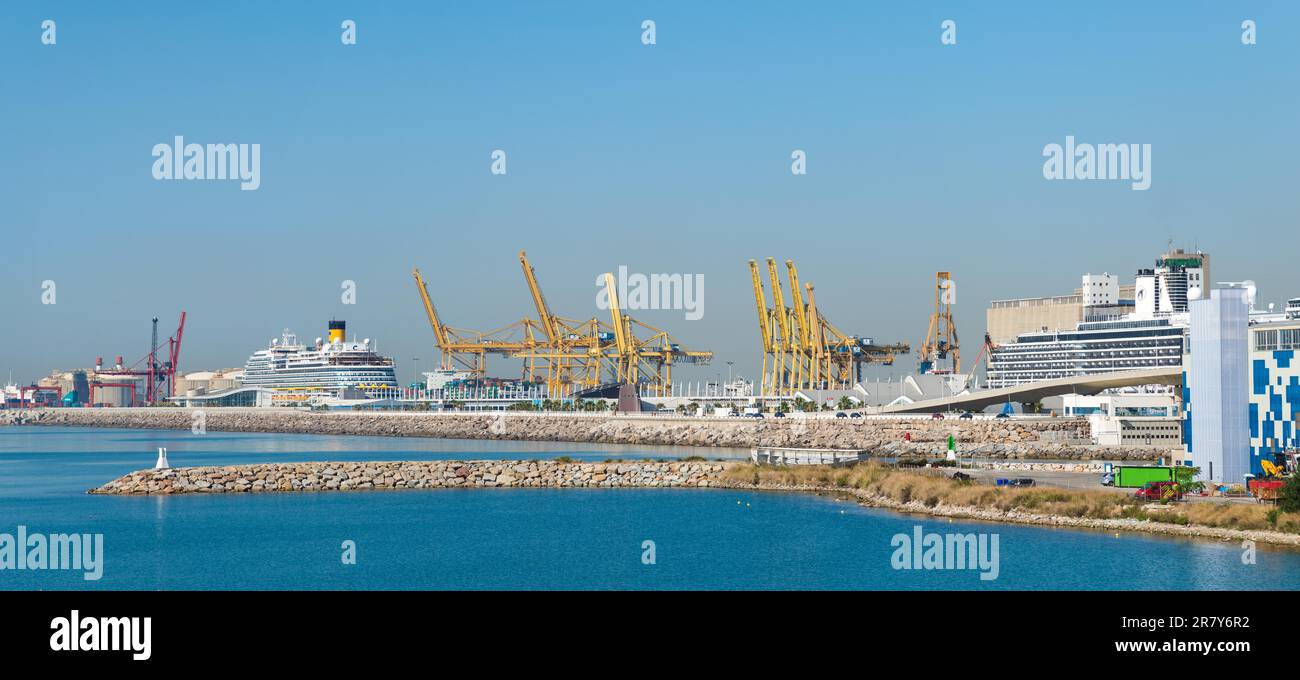 In the foreground an old harbor basin and the cruise port of Barcelona with cruise ships, moored at the pier. The Zona Franca Port is located in the Stock Photo