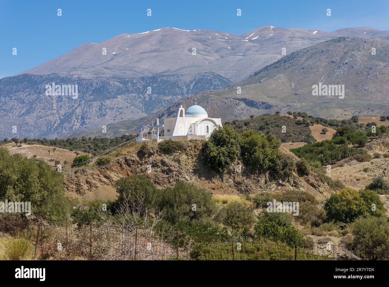 On the old road to Rethymno. White greek orthodox church in the ...