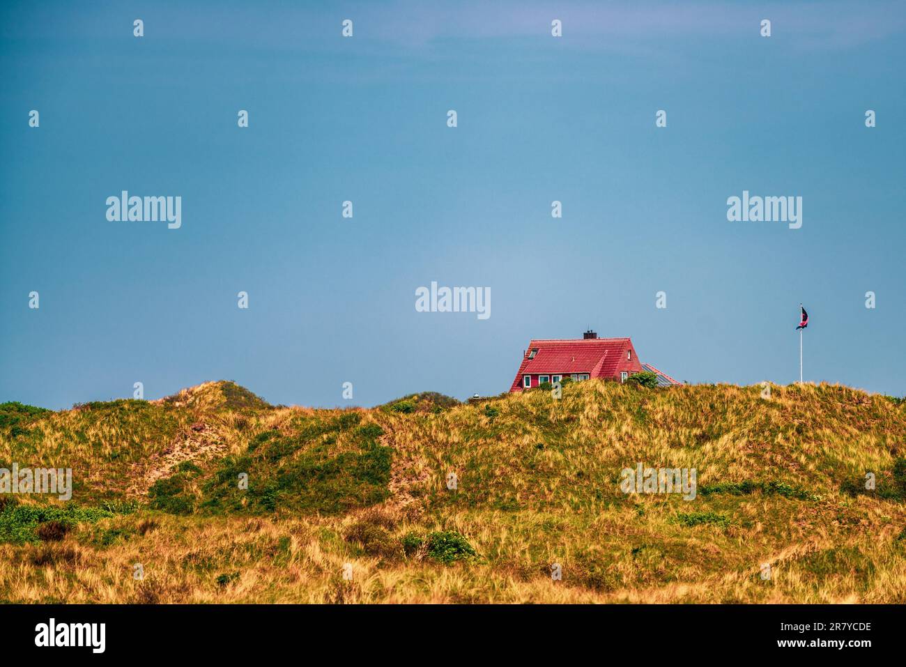 Sand dune and a holiday home on the island of Juist, Germany Stock Photo