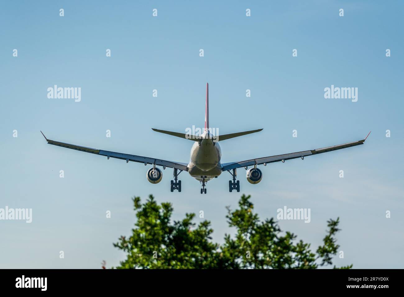 Airplane prepares for landing with extended landing gear Stock Photo