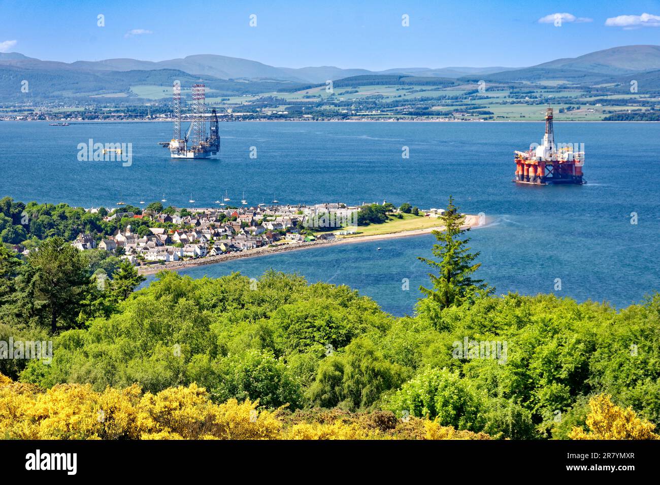 Cromarty Scotland Cromarty Firth view over the town the houses and orange oil rig towards the hills in early summer Stock Photo
