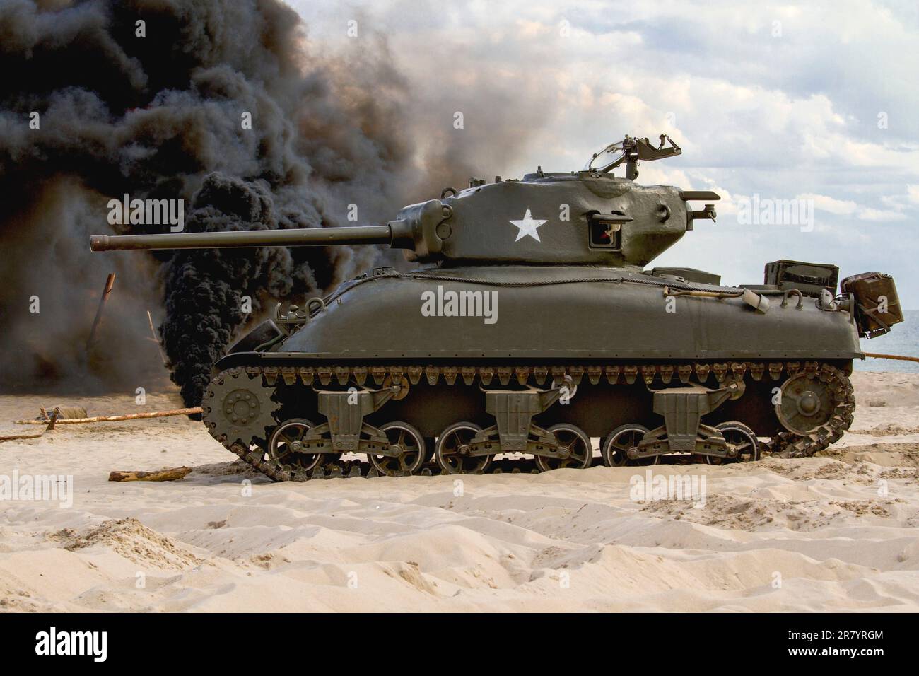 An American World War II Sherman tank on the beach. Tank in the field of battle. Stock Photo
