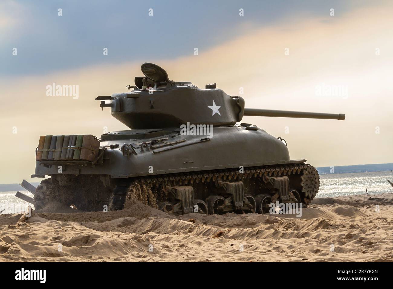 An American World War II Sherman tank on the beach. Tank in the field of battle. Stock Photo