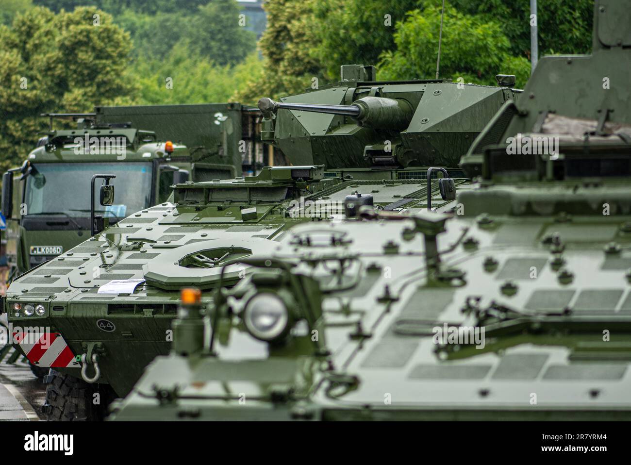 Armoured tanks and military infantry fighting vehicles ready to move under the rain, Lithuanian Land Force, NATO response force Stock Photo