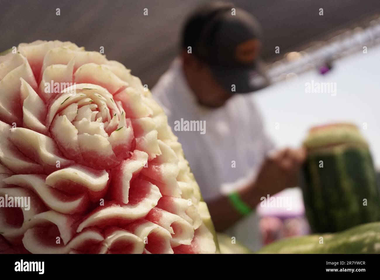 Los Angeles, USA. 17th June, 2023. An artist carves a watermelon during