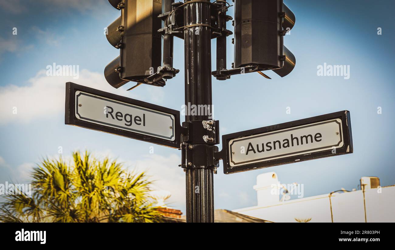 An image with a signpost pointing in two different directions in German. One direction points by exception, the other points by rule. Stock Photo