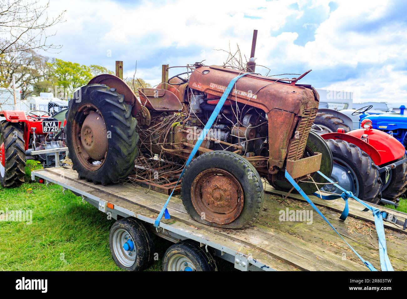 An unrestored ‘barn find’ Massey Ferguson tractor on a trailer at the