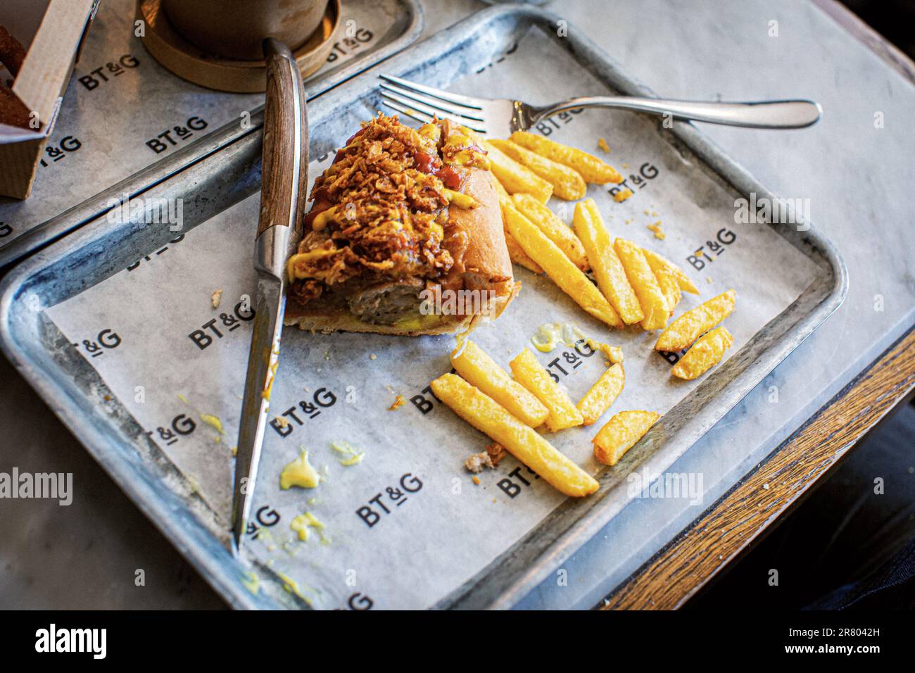 Hotdog and chips at The Butchers Tap and Grill in Marlow, Buckinghamshire, UK Stock Photo