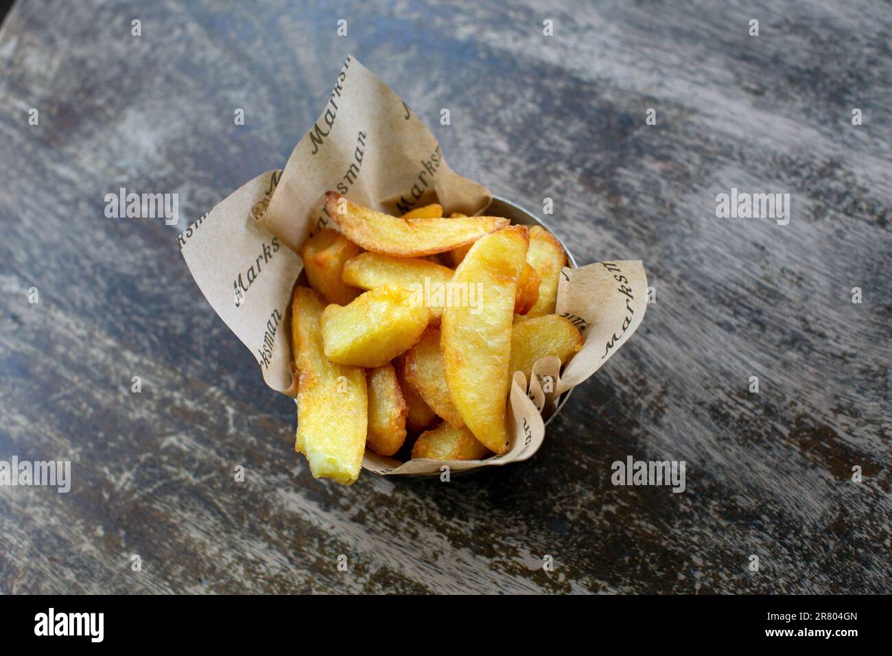 Potato chips on wooden table Stock Photo
