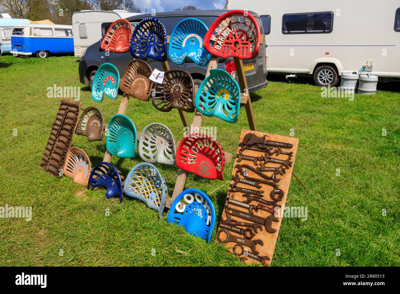 A colourful selection of vintage metal tractor seats displayed at the Abbey Hill Steam Rally, Yeovil, England, Somerset, UK Stock Photo