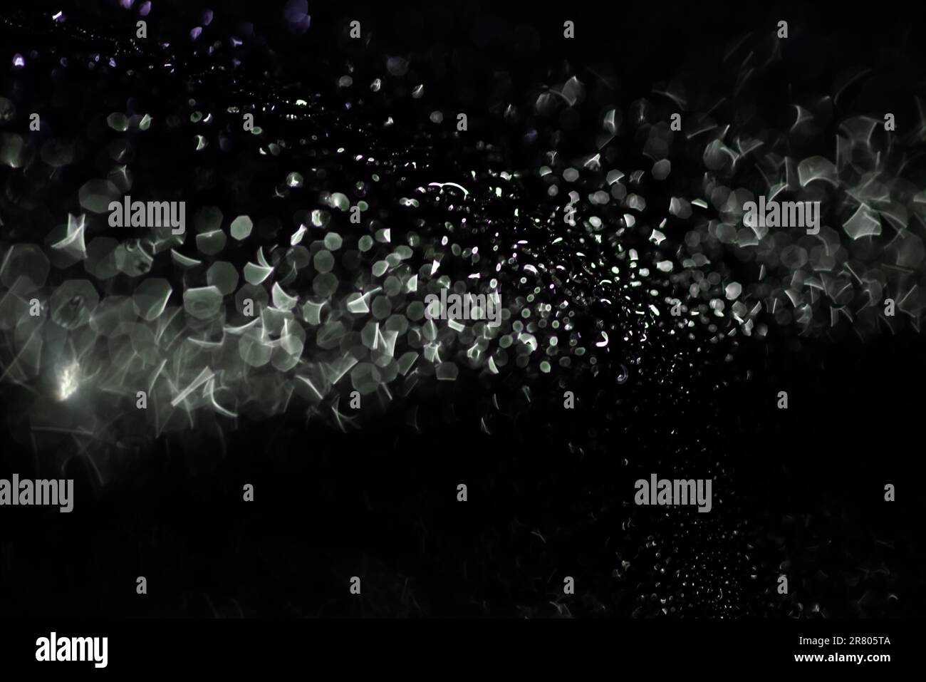Abstract silver bokeh on black background Stock Photo