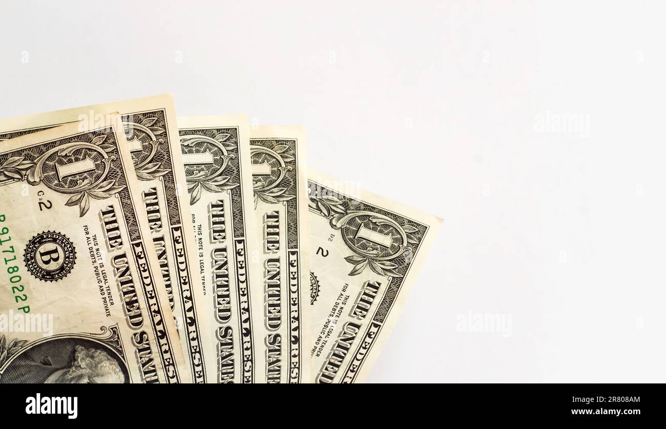 One US Dollar bills on white surface with large copy space Stock Photo
