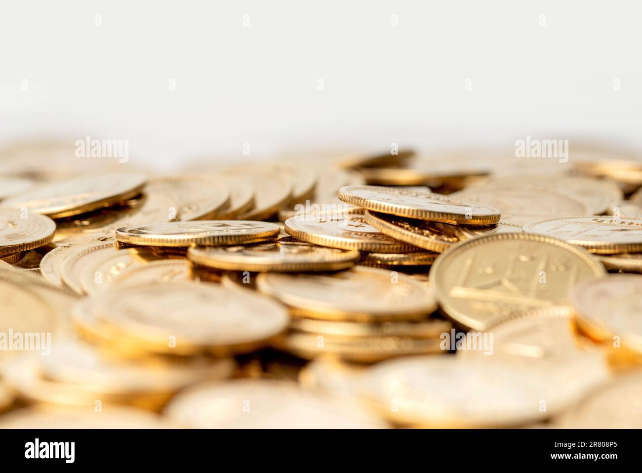 Stacks of gold coins of Pakistani currency symbolize wealth and