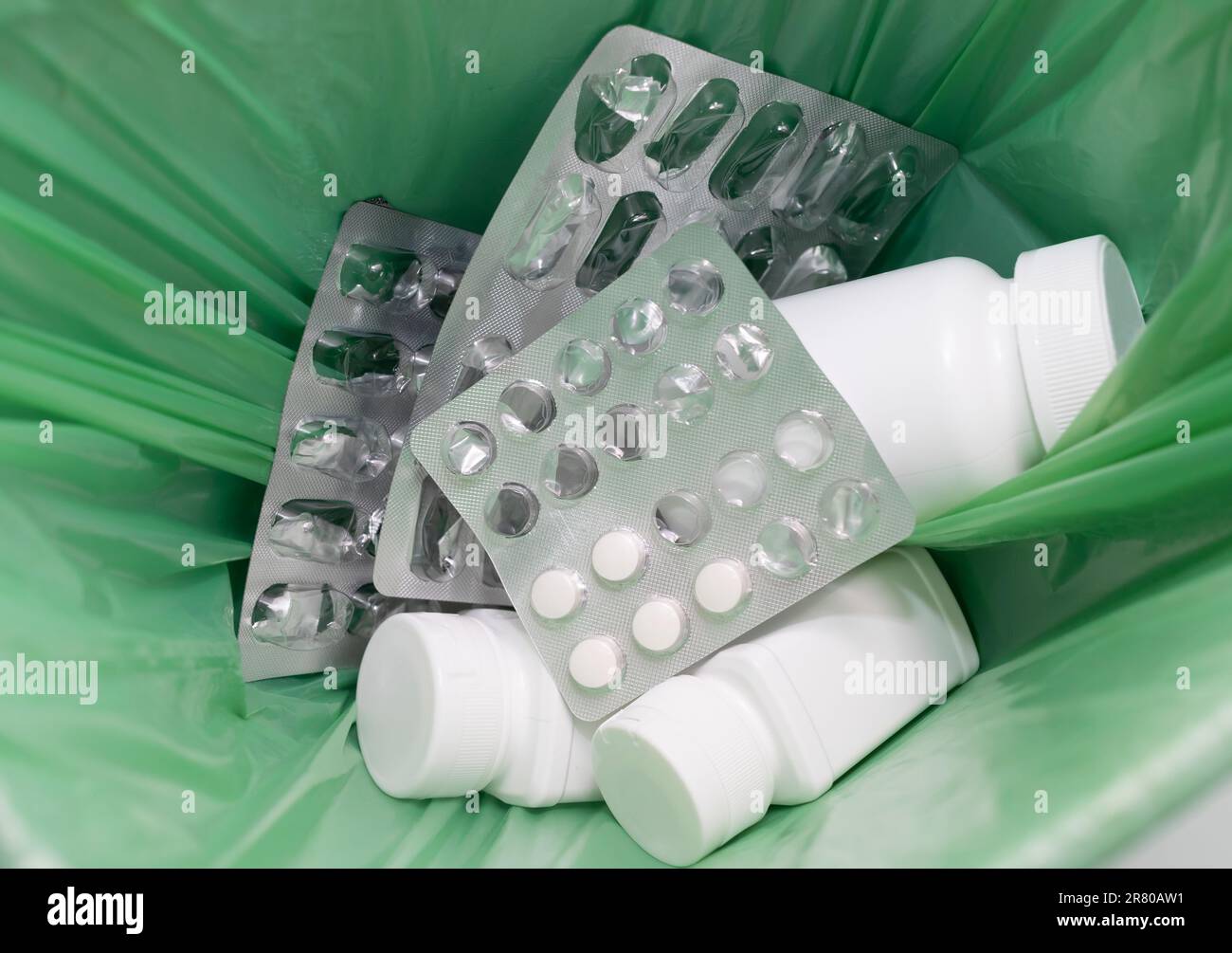 https://c8.alamy.com/comp/2R80AW1/closeup-garbage-can-trash-bin-full-of-medication-pills-tablet-bottles-empty-capsule-pastilles-medical-waste-supplement-over-consumption-concept-2R80AW1.jpg