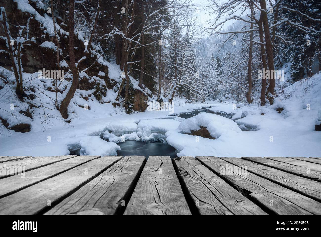 River flowing In winter time with empty wooden batten bridge. Natural ...