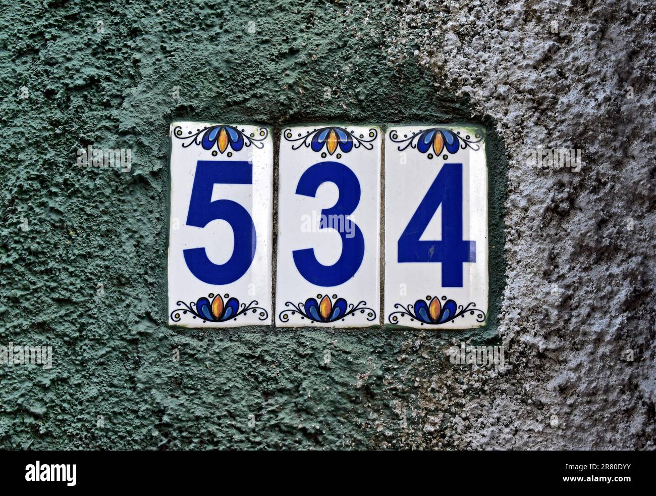 Street sign number 534 on a grey wall Stock Photo
