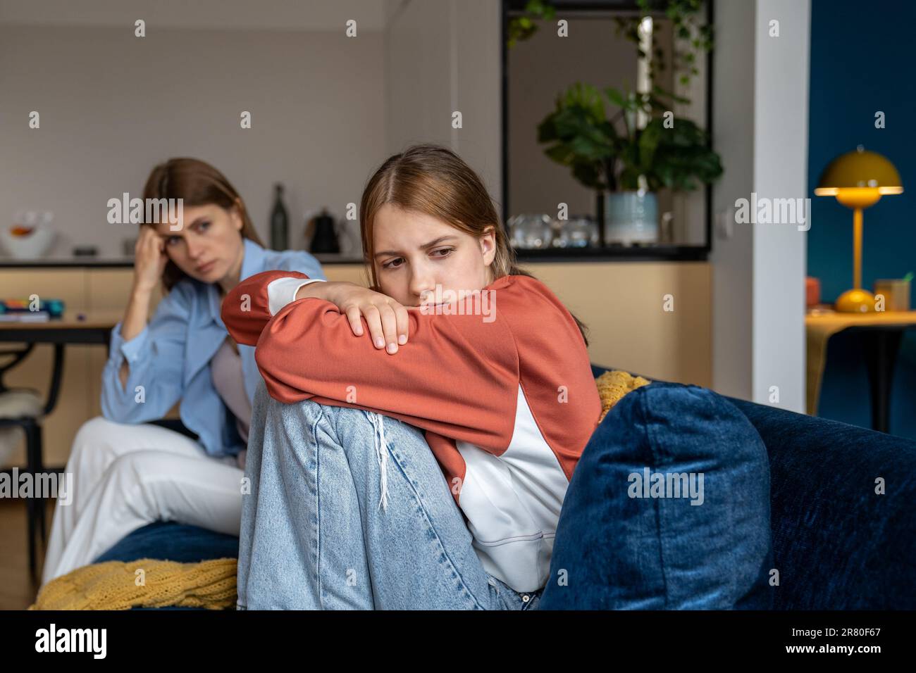 Frustrated Offended Teenage Girl Sits Hugging Knees And Looks Away Mom 