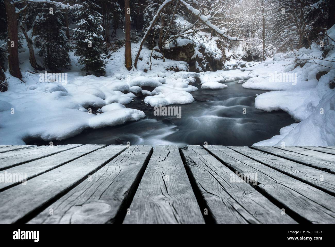 River flowing In winter time with empty wooden batten bridge. Natural ...