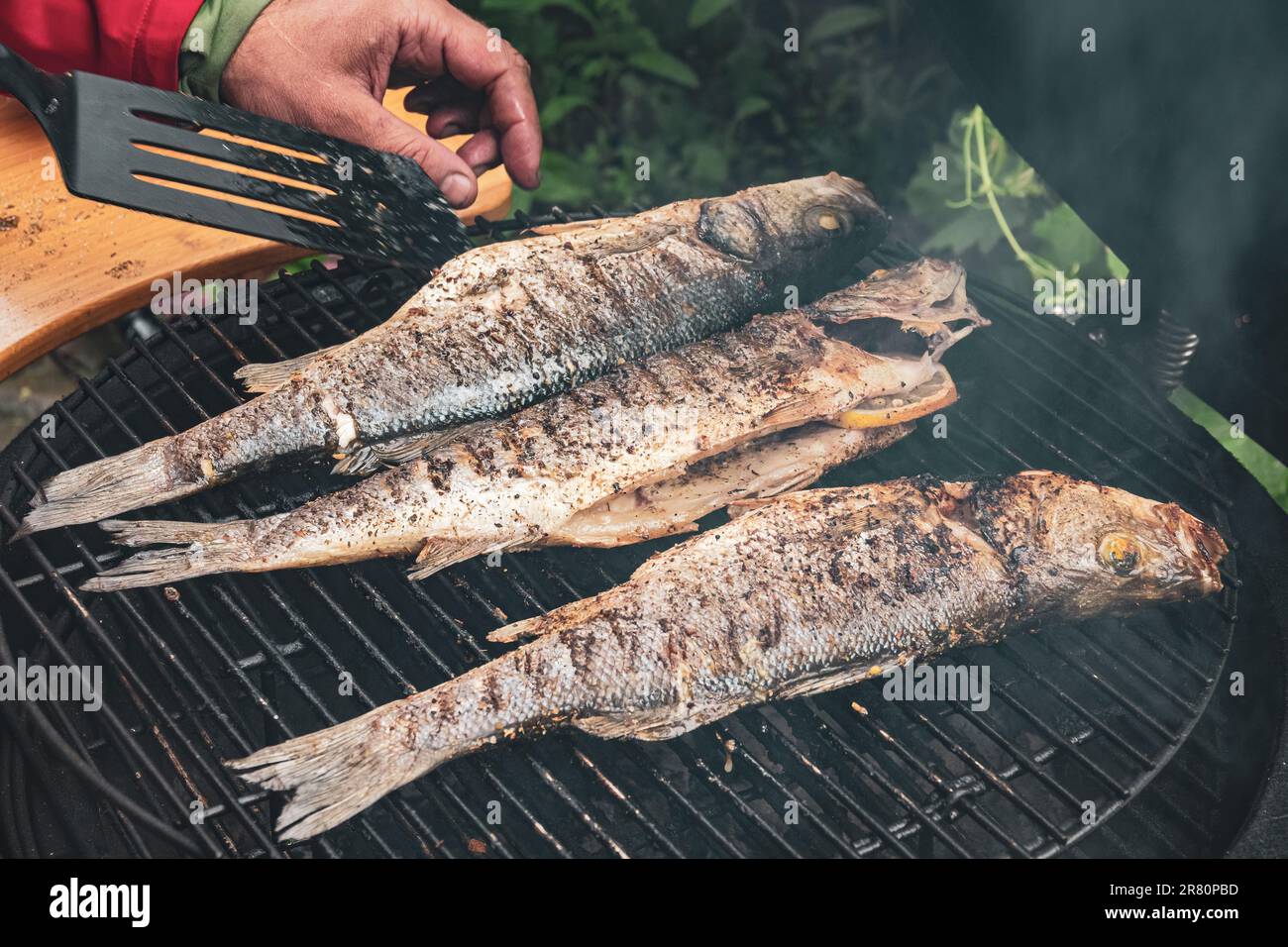 Delicious grilled fish on the barbeque grille. Summer BBQ party Stock