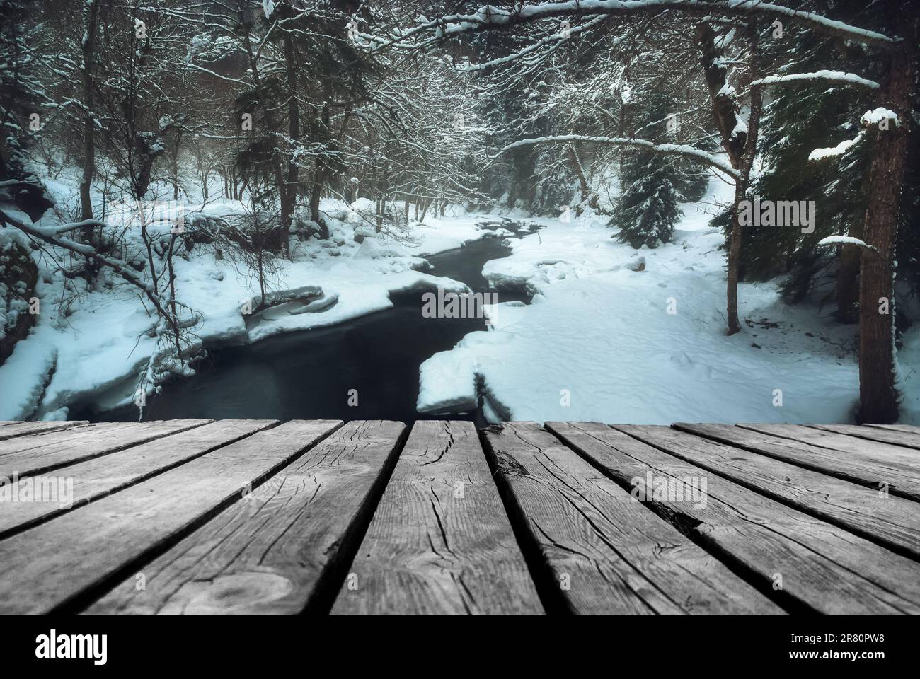 River flowing In winter time with empty wooden batten bridge. Natural ...