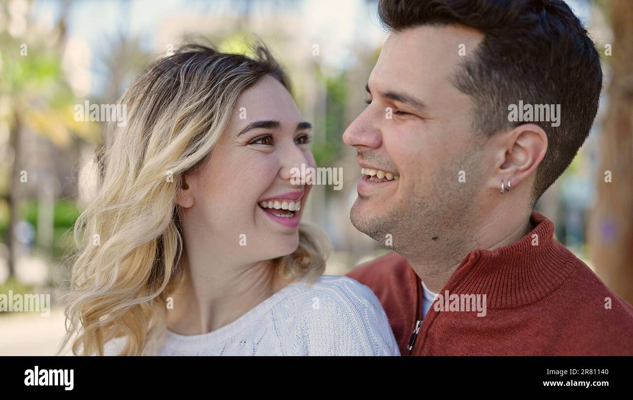 Man and woman couple smiling confident standing together at park Stock ...