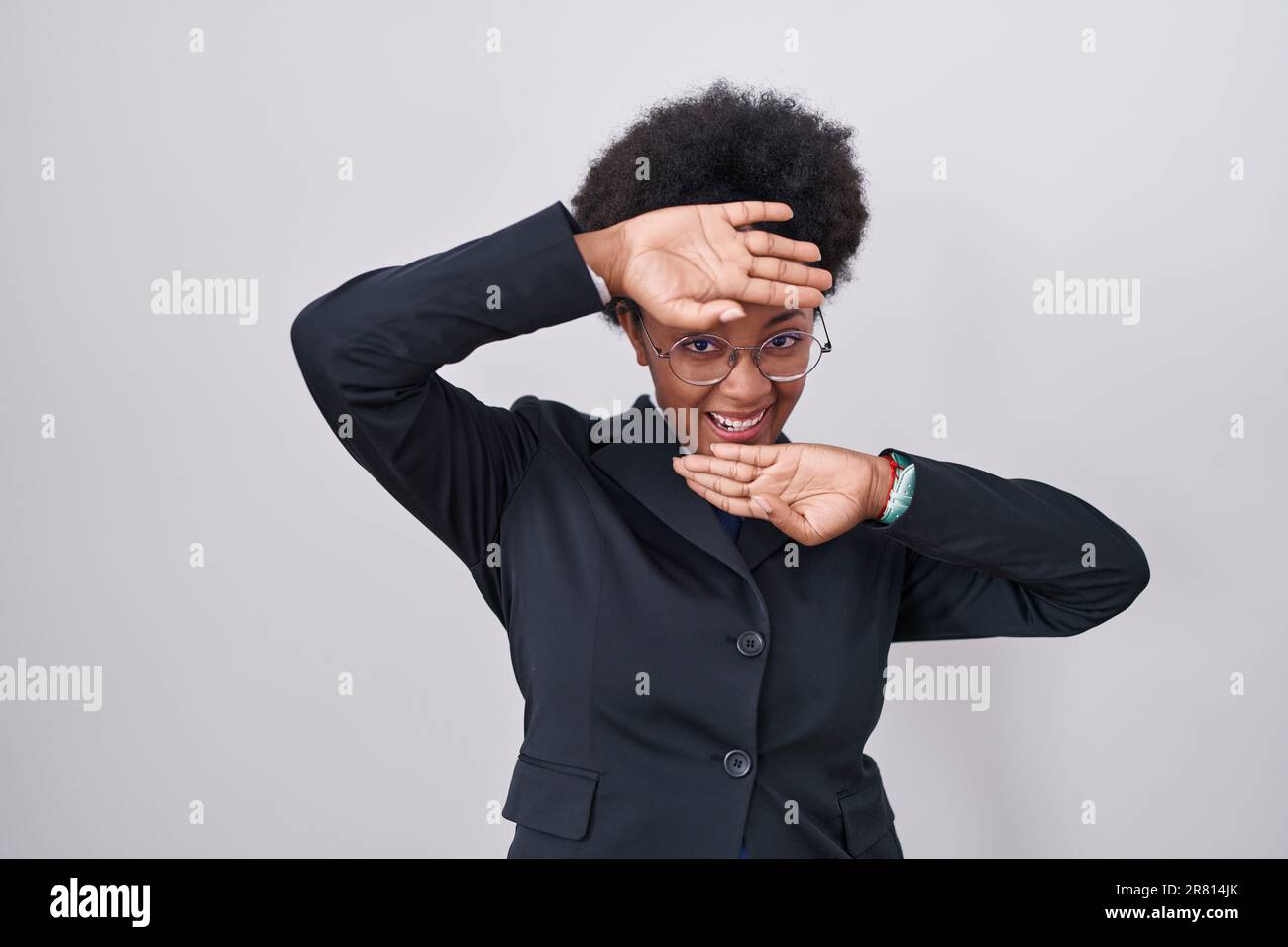 Beautiful african woman with curly hair wearing business jacket and ...