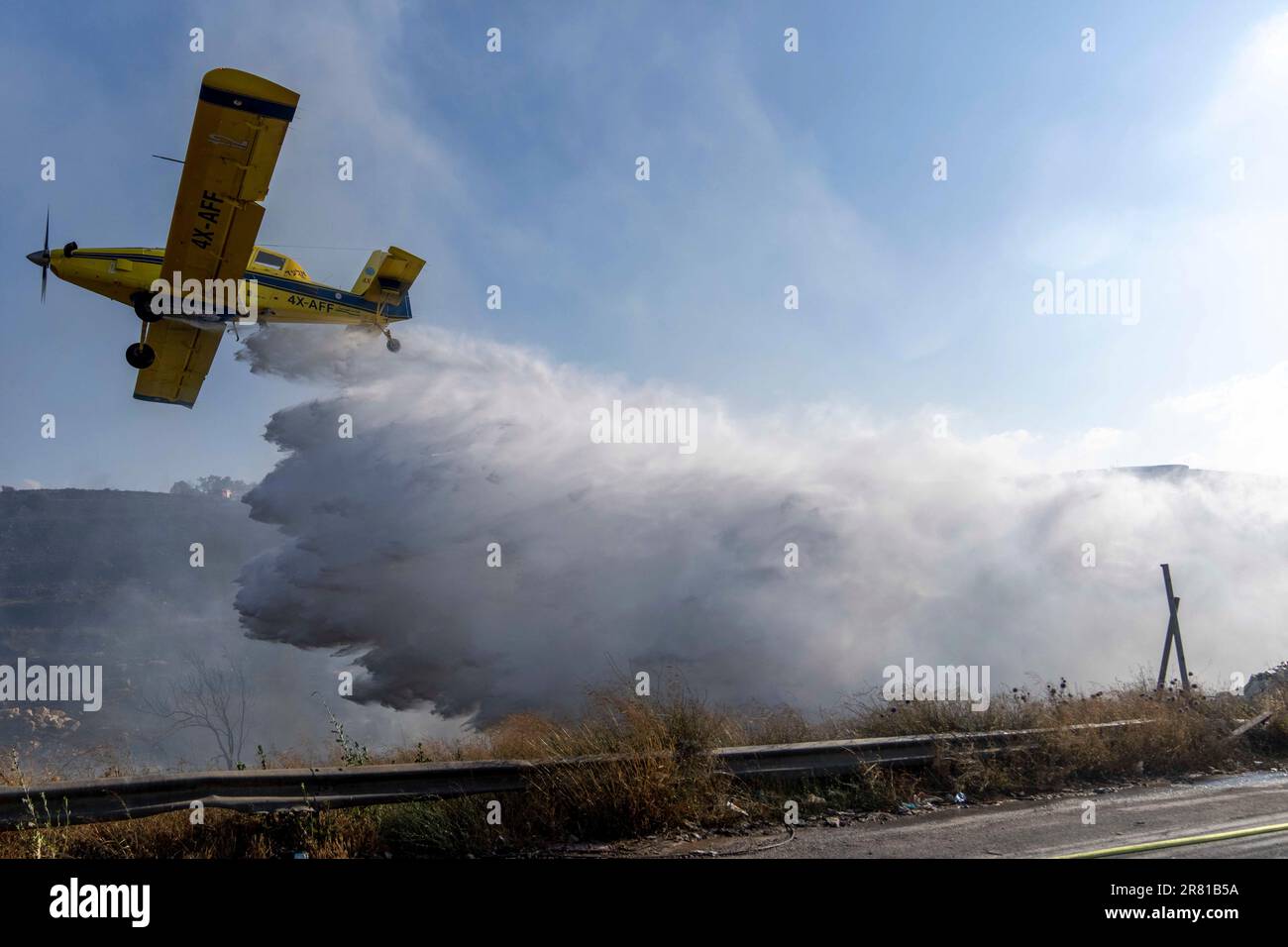 A firefighting aircraft drops fire retardant material in efforts to ...