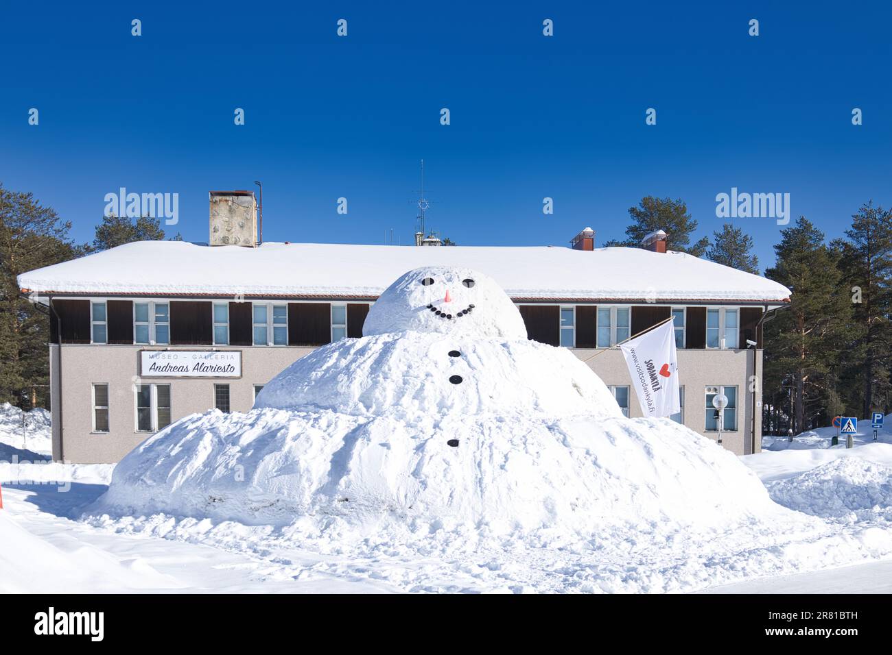 Sodankyla, Finland - a winter snow scene with a giant snowman in front of the town museum and gallery Stock Photo