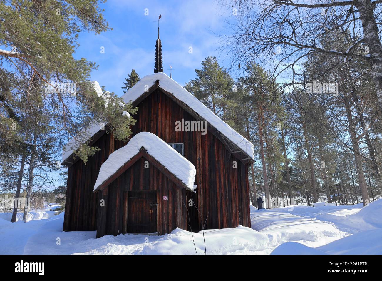 Sodankylä Old Church, Finland pictured in winter snow in woodland on the banks of the River Kitinen, it is one of Finland’s oldest churches Stock Photo
