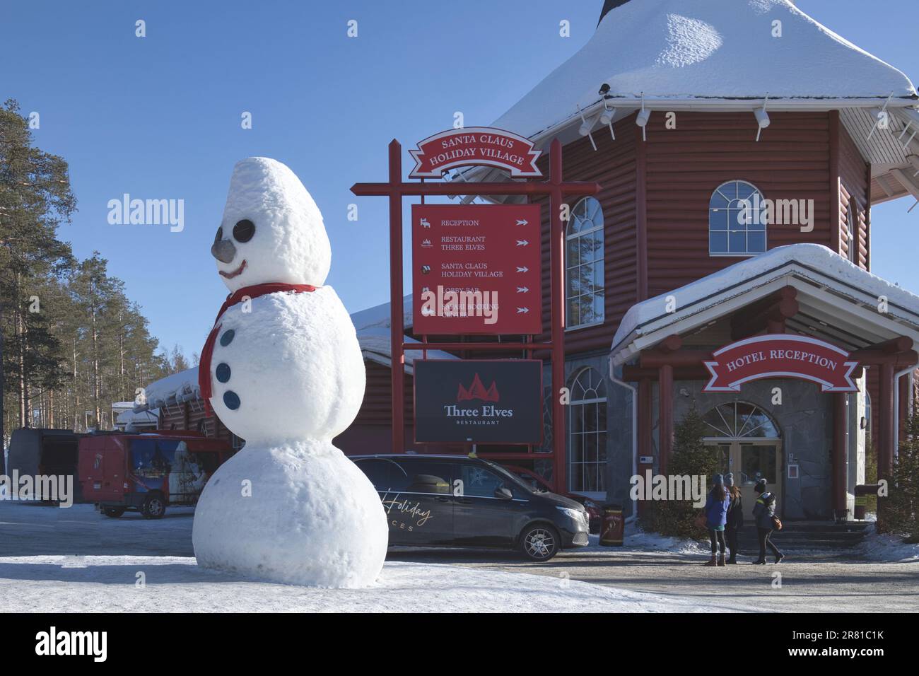 Santa Claus Village, Arctic Circle, Rovaniemi, Lapland, Finland, winter with snow - tourists and giant snowman outside hotel Stock Photo