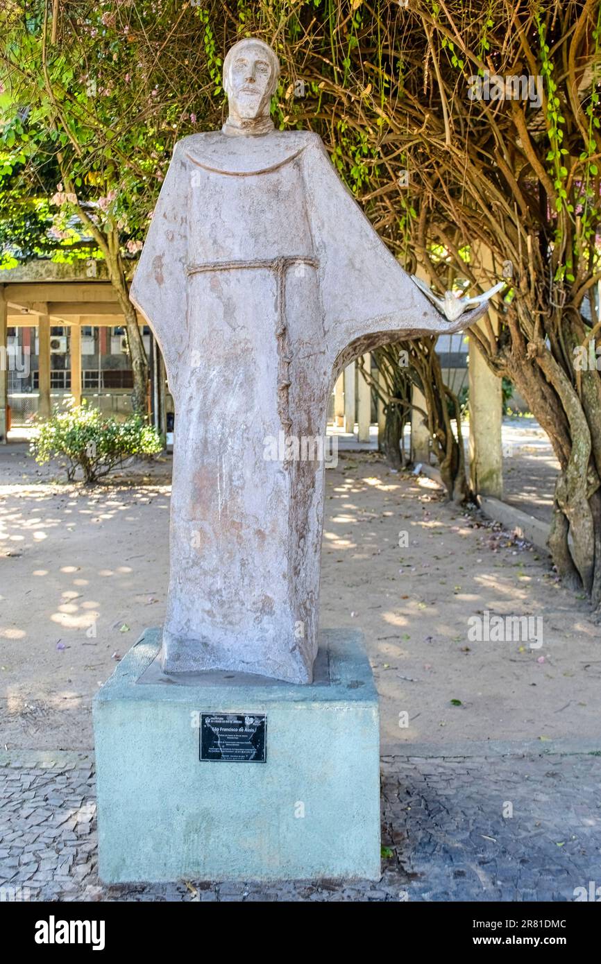 Rio de Janeiro, Brazil - May 25, 2023: Statue of a man in the Copacabana District wearing a white robe with a waist girdle. This religious monument sh Stock Photo