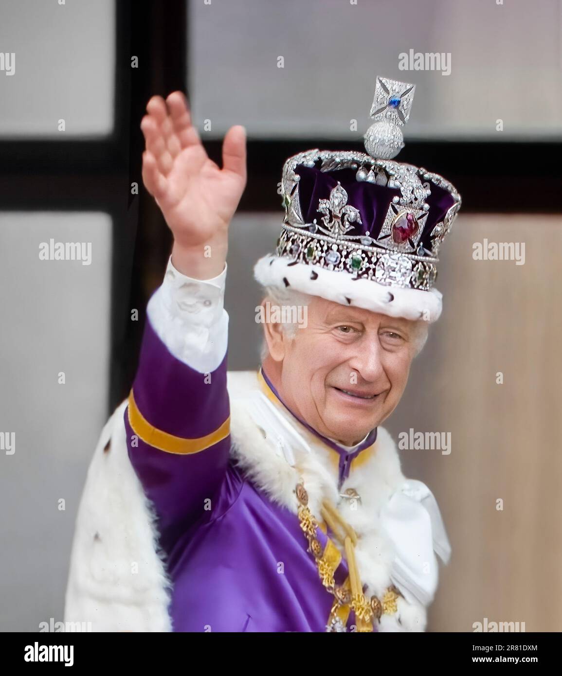 King Charles III waving from the balcony at Buckingham Palace, wearing The Crown of State (The Imperial State Crown) and his coronation robes, waves a thank you to the crowds below, from the balcony of Buckingham Palace, after his and Queen Camilla's Coronation at Westminster Abbey Westminster London May 6th 2023 Stock Photo